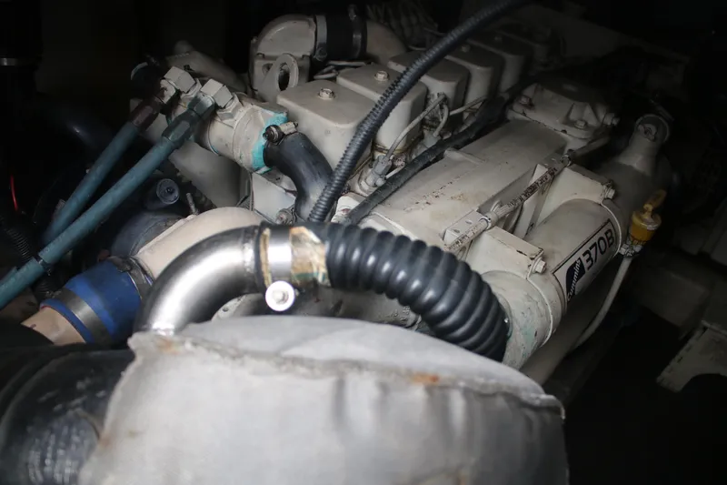 Plane Pirate Yacht Photos Pics Engine compartment of a 2004 Riviera 37 Convertible boat, featuring Cummins 370B engine.