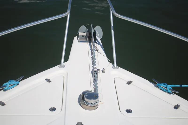Plane Pirate Yacht Photos Pics Bow of 2004 Riviera 37 Convertible yacht with anchor chain and railing.