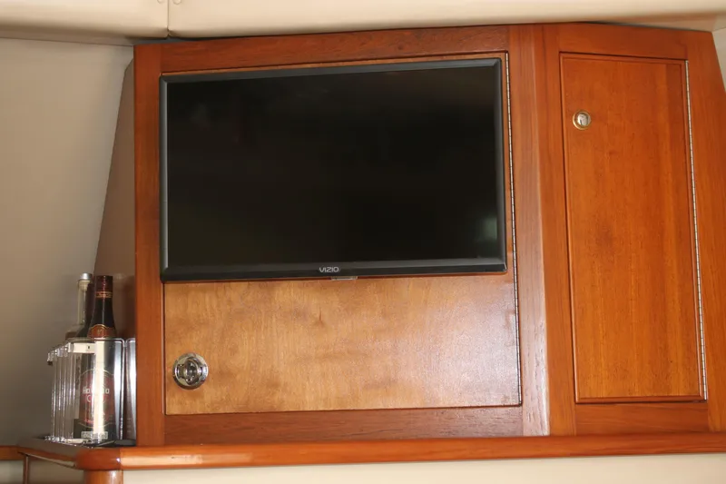 Plane Pirate Yacht Photos Pics 2004 Riviera 37 Convertible interior with TV and wooden cabinetry.