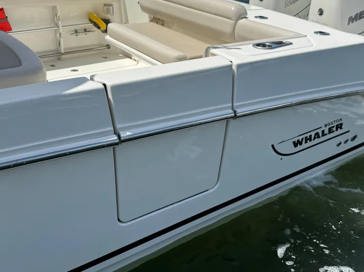 Yacht Photos Pics 2018 Boston Whaler 330 Outrage boat, white exterior, docked on water.
