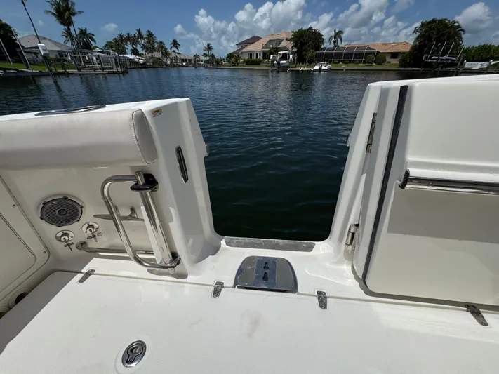  Yacht Photos Pics 2018 Boston Whaler 330 Outrage boat deck overlooking serene waterfront view.