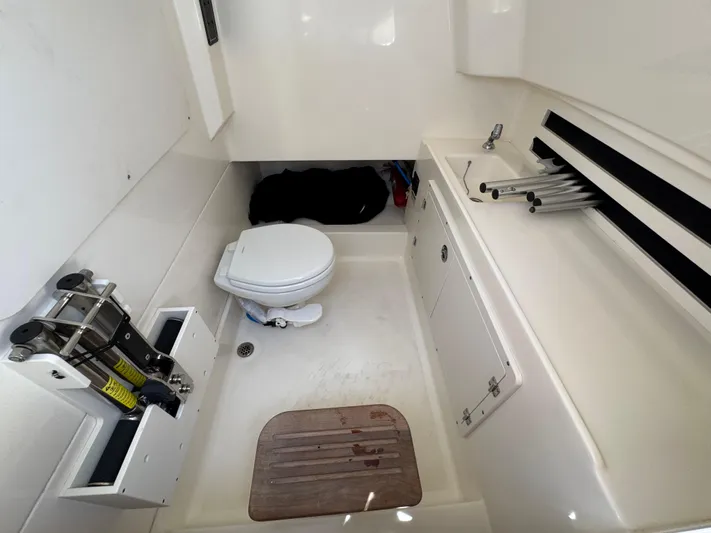  Yacht Photos Pics 2018 Boston Whaler 330 Outrage cabin with toilet and storage area.
