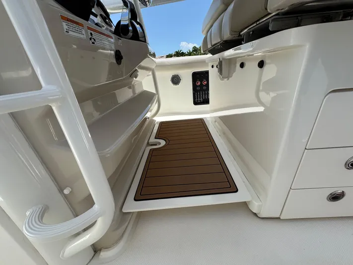  Yacht Photos Pics 2018 Boston Whaler 330 Outrage interior with teak flooring and storage compartments.