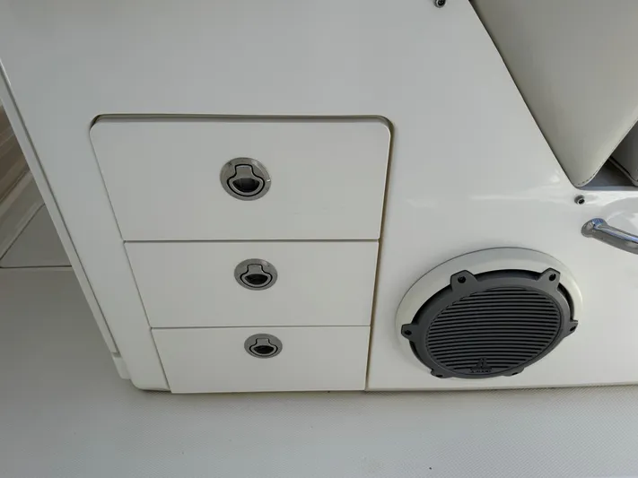  Yacht Photos Pics 2018 Boston Whaler 330 Outrage boat interior with storage drawers and speaker.