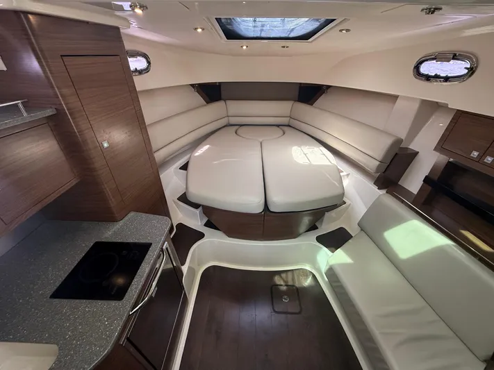  Yacht Photos Pics 2018 Boston Whaler 345 Conquest cabin interior with modern seating and kitchenette.