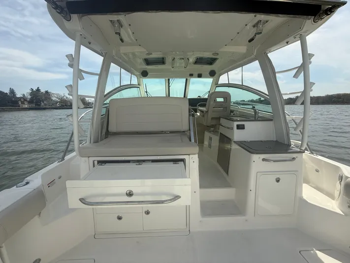  Yacht Photos Pics 2018 Boston Whaler 345 Conquest boat interior with seating and storage, on calm water.