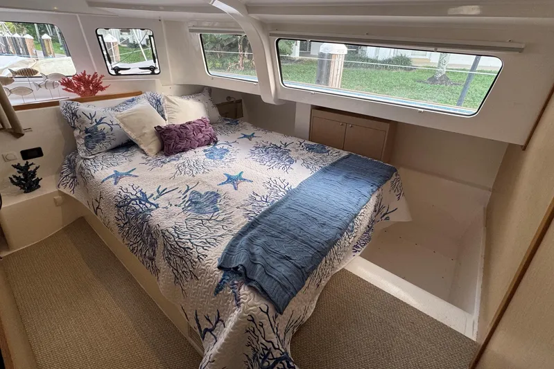  Yacht Photos Pics Cozy bedroom in 2023 NEEL 43 yacht with nautical-themed bedding and large windows.