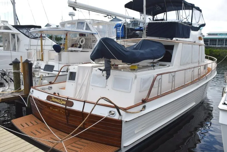 Jamie Lyn Yacht Photos Pics 1997 Grand Banks Classic yacht docked, featuring elegant wooden details and covered upper deck.