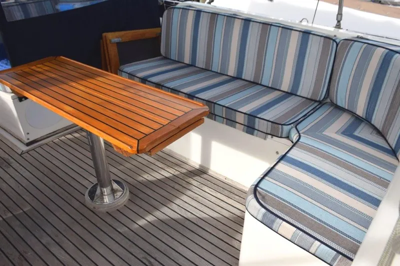 Jamie Lyn Yacht Photos Pics 1997 Grand Banks Classic yacht interior with striped seating and wooden table.