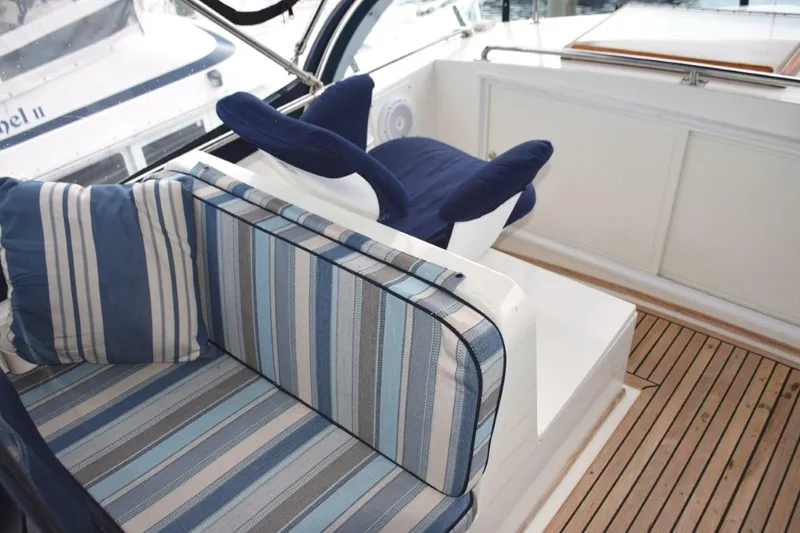 Jamie Lyn Yacht Photos Pics 1997 Grand Banks Classic yacht interior with striped seating and wooden flooring.