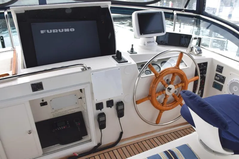 Jamie Lyn Yacht Photos Pics 1997 Grand Banks Classic helm with wooden wheel, navigation equipment, and Furuno display.