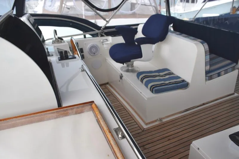 Jamie Lyn Yacht Photos Pics Interior of 1997 Grand Banks Classic yacht with blue seating and wooden deck.