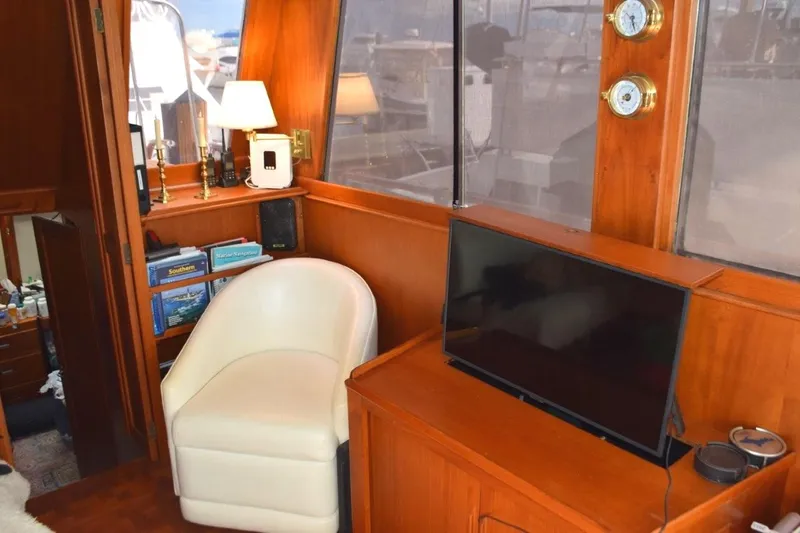 Jamie Lyn Yacht Photos Pics Interior of 1997 Grand Banks Classic yacht with chair, TV, and nautical decor.