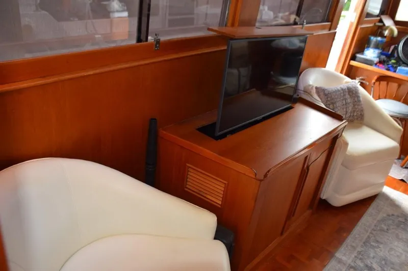 Jamie Lyn Yacht Photos Pics Interior of 1997 Grand Banks Classic yacht with TV and white chairs.