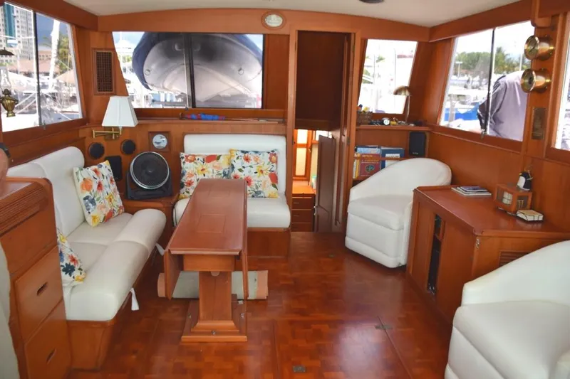 Jamie Lyn Yacht Photos Pics Interior of a 1997 Grand Banks Classic yacht with elegant wood finish and floral cushions.