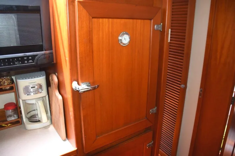 Jamie Lyn Yacht Photos Pics 1997 Grand Banks Classic interior with wooden cabinetry, microwave, and coffee maker.