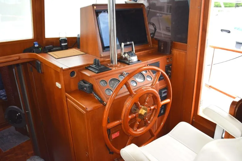 Jamie Lyn Yacht Photos Pics 1997 Grand Banks Classic yacht helm with wooden steering wheel and navigation instruments.