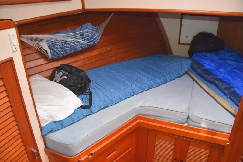 Jamie Lyn Yacht Photos Pics Cozy cabin interior of 1997 Grand Banks Classic boat with bedding and storage.