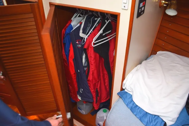 Jamie Lyn Yacht Photos Pics Closet with jackets on hangers inside a 1997 Grand Banks Classic boat cabin.