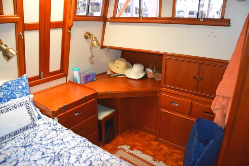Jamie Lyn Yacht Photos Pics Cozy cabin interior of 1997 Grand Banks Classic yacht with wooden furnishings and nautical decor.