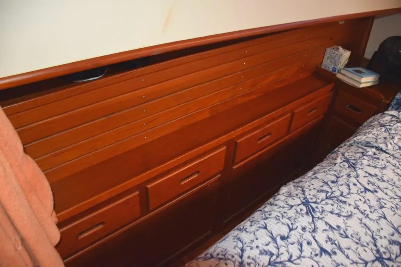 Jamie Lyn Yacht Photos Pics Wooden cabinetry in a 1997 Grand Banks Classic boat interior, featuring drawers and a bed.