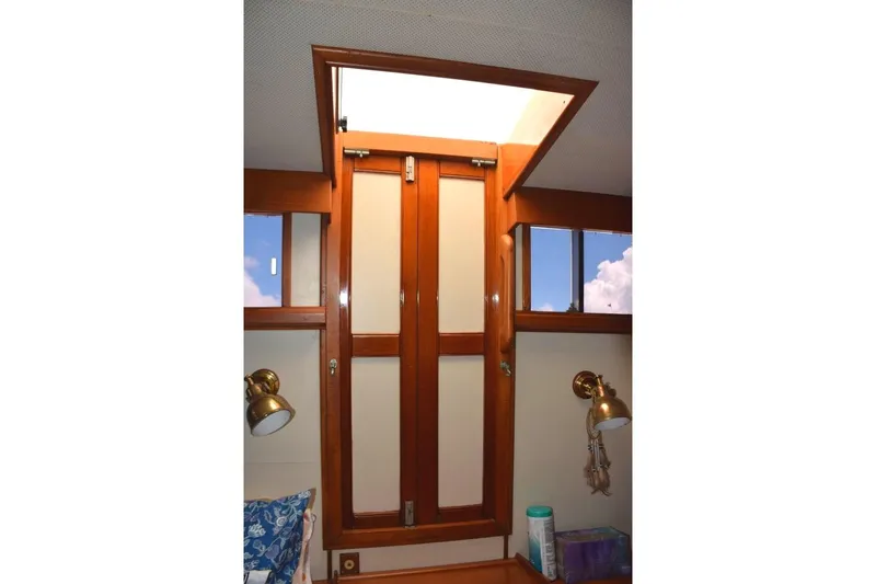 Jamie Lyn Yacht Photos Pics Interior of 1997 Grand Banks Classic yacht with wooden hatch and brass lighting.