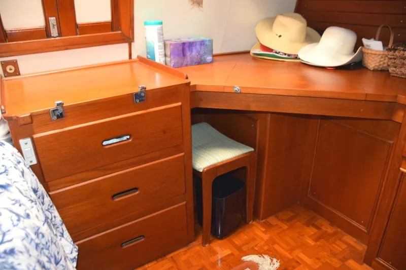 Jamie Lyn Yacht Photos Pics 1997 Grand Banks Classic interior with wooden cabinetry and desk, featuring hats and storage.