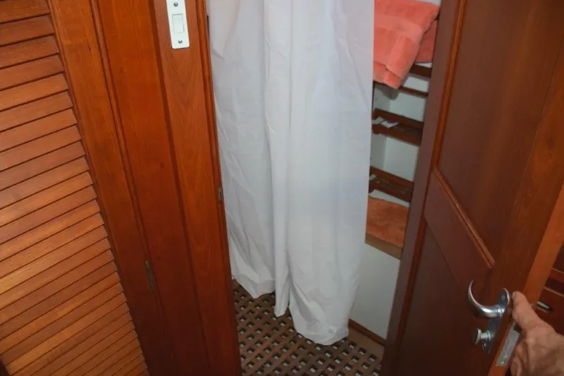 Jamie Lyn Yacht Photos Pics Interior of 1997 Grand Banks Classic yacht with wooden doors and white curtain.