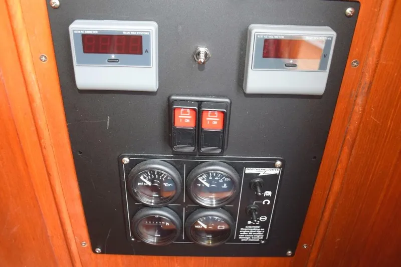 Jamie Lyn Yacht Photos Pics Control panel of a 1997 Grand Banks Classic boat with gauges and switches.