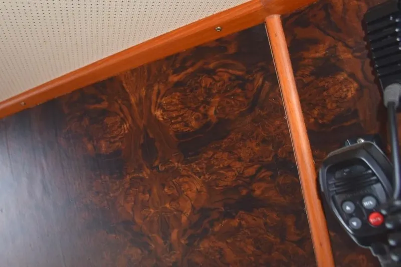 Jamie Lyn Yacht Photos Pics Interior detail of 1997 Grand Banks Classic boat with wood paneling and communication device.