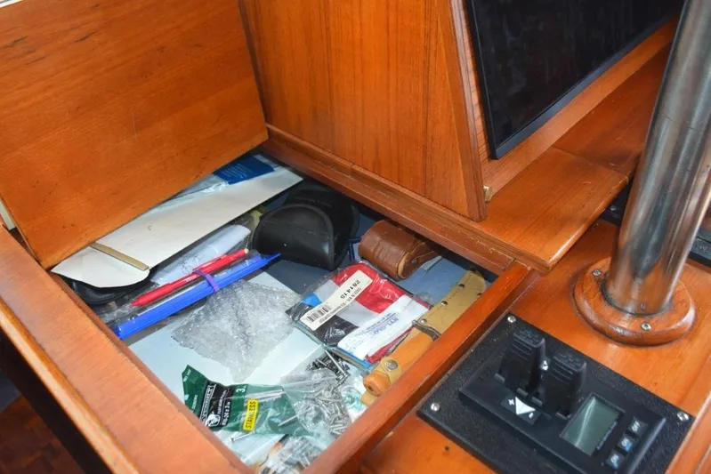 Jamie Lyn Yacht Photos Pics Interior storage compartment on a 1997 Grand Banks Classic boat with various items.