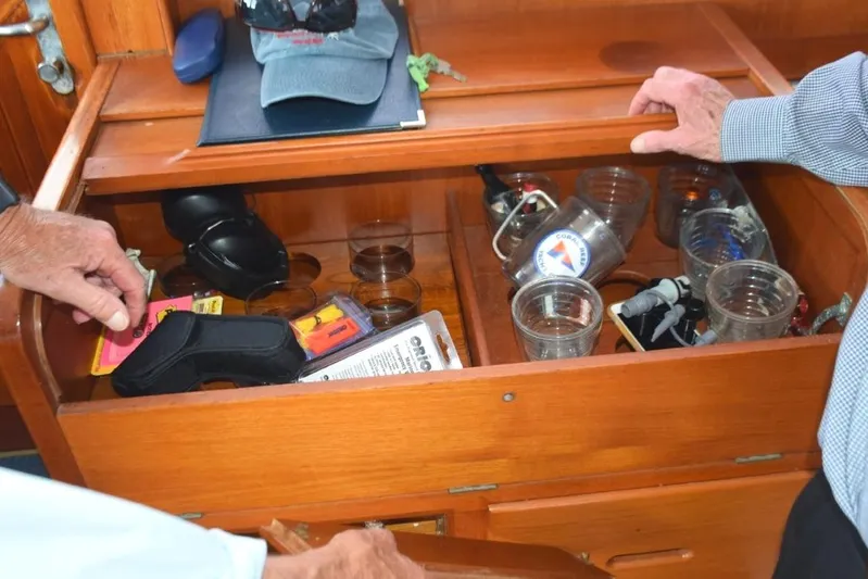 Jamie Lyn Yacht Photos Pics Interior of a 1997 Grand Banks Classic boat with open wooden storage compartment.