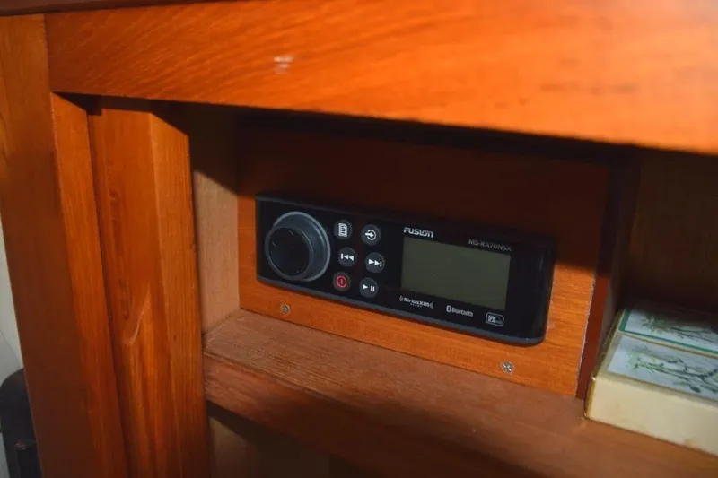 Jamie Lyn Yacht Photos Pics 1997 Grand Banks Classic interior with Fusion audio system installed in wooden cabinet.