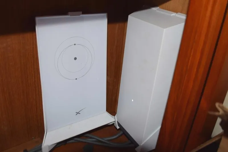 Jamie Lyn Yacht Photos Pics Wi-Fi router setup inside a 1997 Grand Banks Classic boat cabinet.