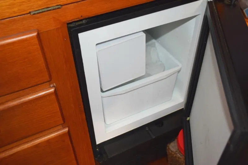 Jamie Lyn Yacht Photos Pics Ice maker inside a 1997 Grand Banks Classic boat's wooden cabinet.