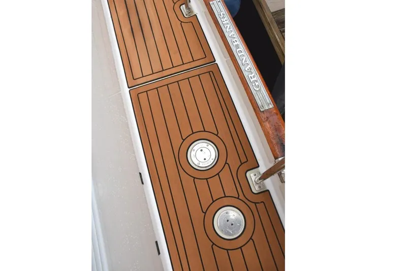 Jamie Lyn Yacht Photos Pics 1997 Grand Banks Classic boat deck with teak finish and branded metal plate.