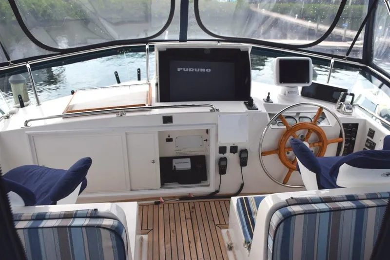Jamie Lyn Yacht Photos Pics 1997 Grand Banks Classic yacht helm with wooden wheel and navigation equipment.