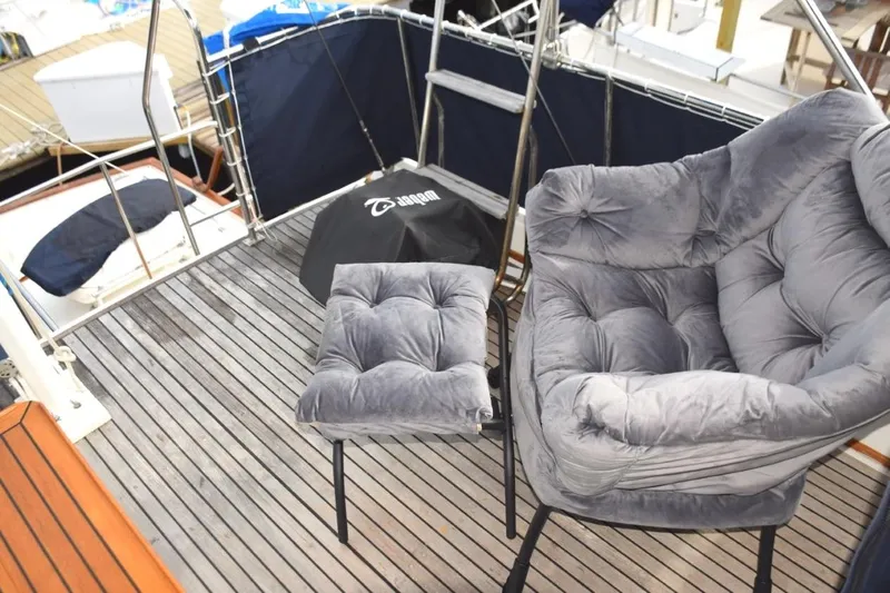 Jamie Lyn Yacht Photos Pics Luxury seating on 1997 Grand Banks Classic yacht deck with plush chair and footrest.
