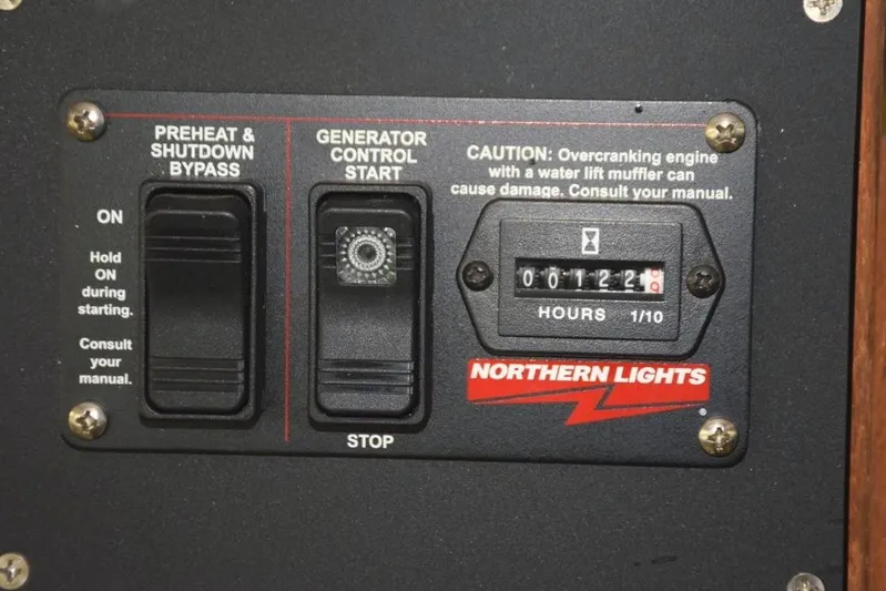 Jamie Lyn Yacht Photos Pics 1997 Grand Banks Classic generator control panel with hour meter and caution label.