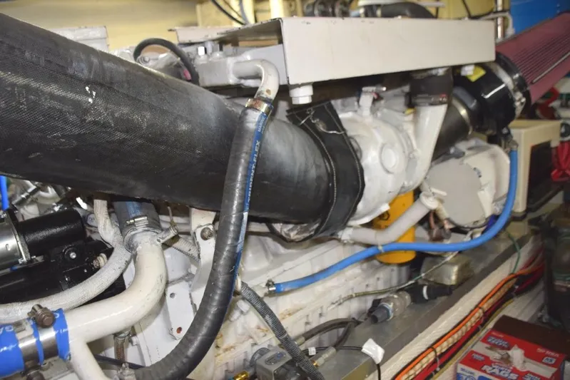 Jamie Lyn Yacht Photos Pics Engine compartment of a 1997 Grand Banks Classic boat, showcasing hoses and mechanical components.