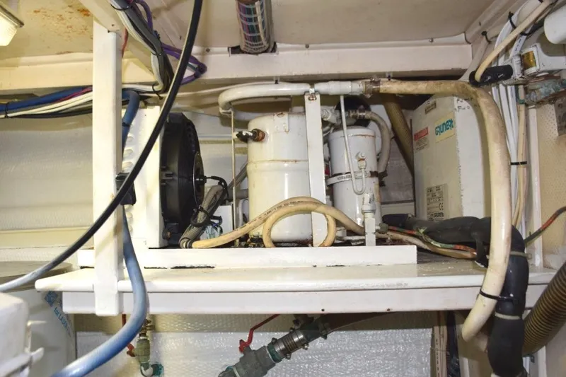 Jamie Lyn Yacht Photos Pics Engine room of a 1997 Grand Banks Classic boat with visible machinery and wiring.