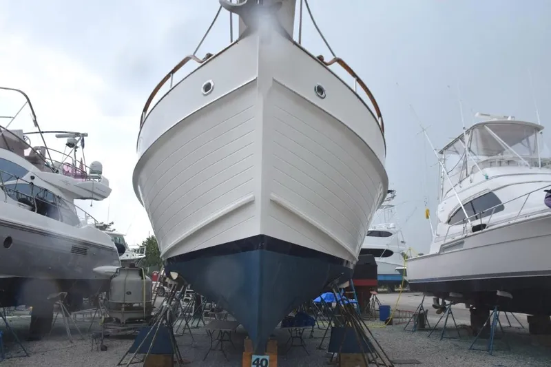 Jamie Lyn Yacht Photos Pics 1997 Grand Banks Classic yacht in dry dock, surrounded by other boats.