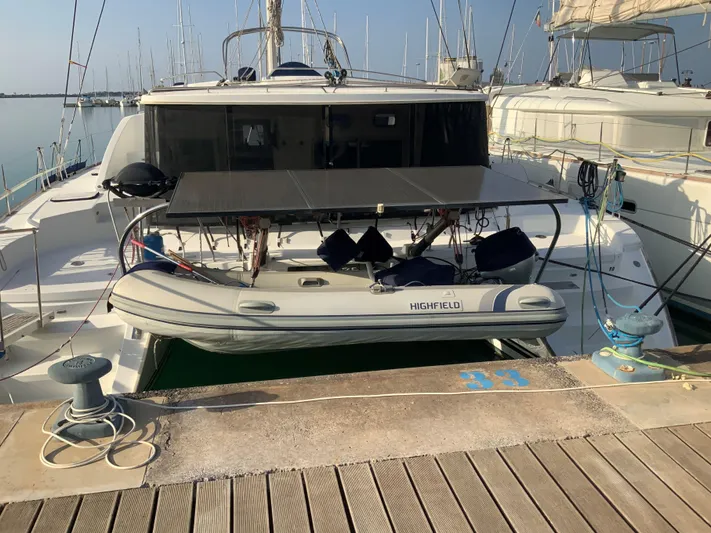  Yacht Photos Pics 2007 Lagoon 440 catamaran docked with inflatable dinghy at marina.