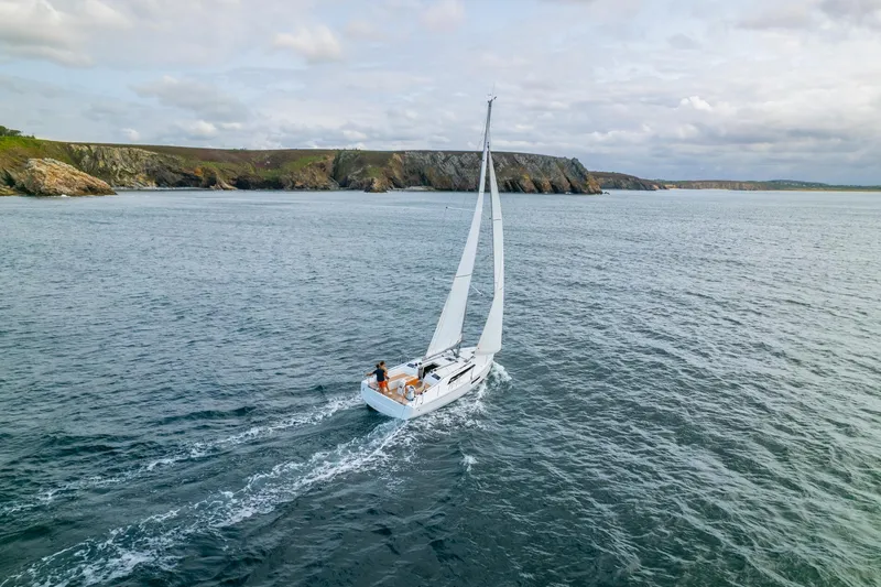 Show Boat! Special Pricing Yacht Photos Pics 2024 Beneteau Oceanis 37.1 sailing near rocky coastline.