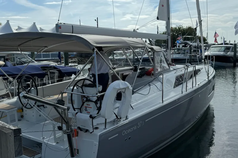 Show Boat! Special Pricing Yacht Photos Pics 2024 Beneteau Oceanis 37.1 sailboat docked at marina, showcasing sleek design and modern features.
