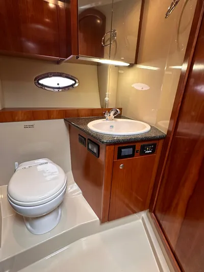 Majestic Yacht Photos Pics 2006 Cruisers Yachts 420 Express bathroom with wood cabinetry and modern fixtures.