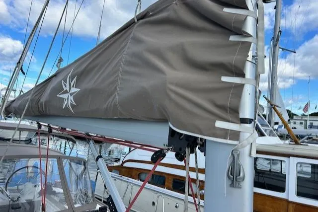Patience Yacht Photos Pics Jeanneau Sun Odyssey 379 sailboat, 2012 model, docked with sail cover, blue sky background.