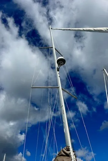 Patience Yacht Photos Pics Sailboat mast of 2012 Jeanneau Sun Odyssey 379 against cloudy sky.