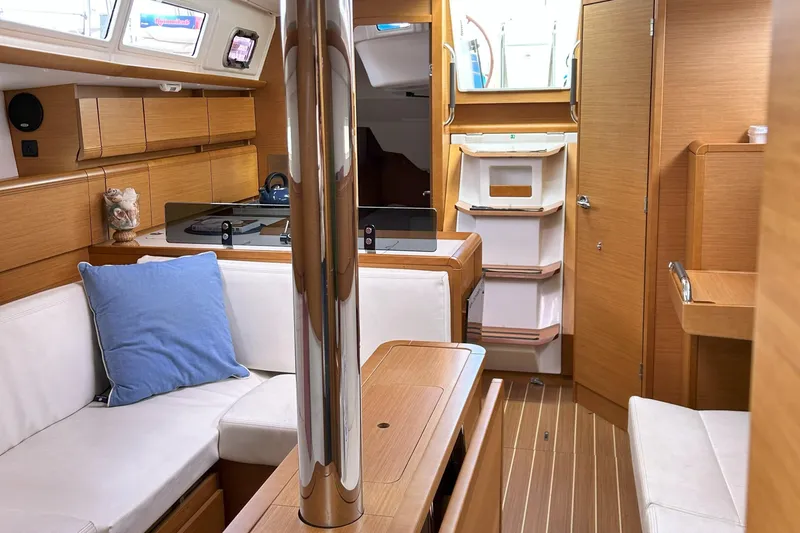 Patience Yacht Photos Pics Interior of 2012 Jeanneau Sun Odyssey 379 sailboat with modern wood finish and cozy seating.