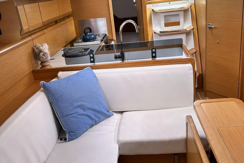 Patience Yacht Photos Pics Interior of 2012 Jeanneau Sun Odyssey 379 yacht with cozy seating and modern kitchen area.